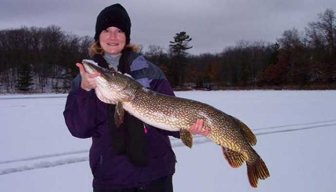 Woman holding a northern pike