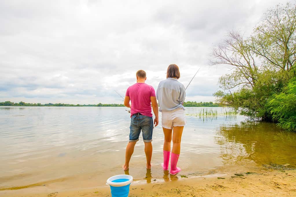 man and woman fishing a lake